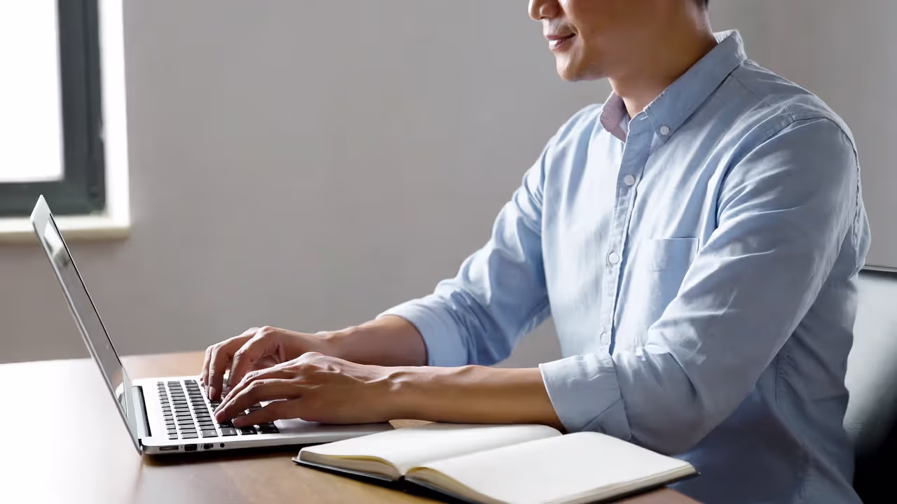 Calm professional working confidently at desk in natural daylight